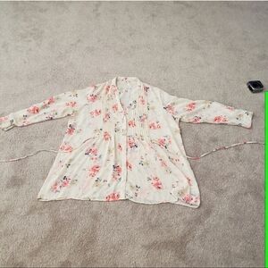 Neon pink flowers float on semi sheer cream pleats